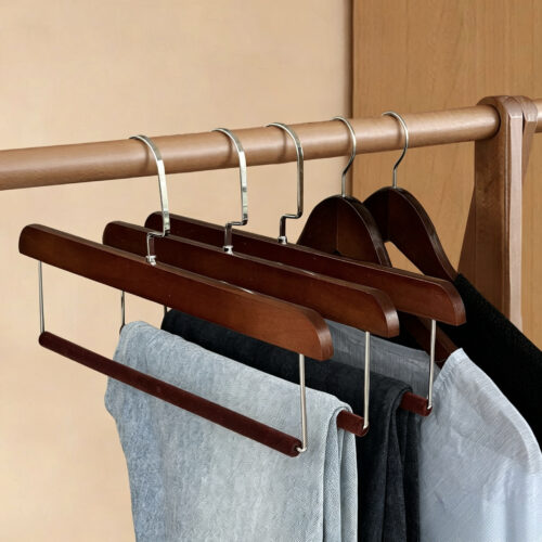 Black pant hangers arranged for bulk retail orders