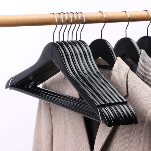 Black wooden hangers inspection before packing