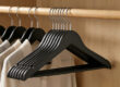 Black wooden suit hangers for retail display