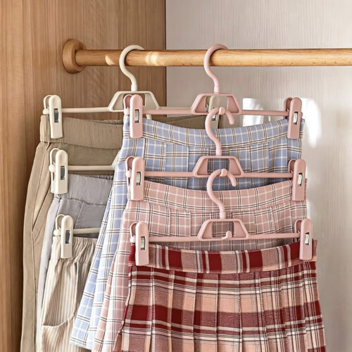 Retail pant hangers displayed with folded trousers
